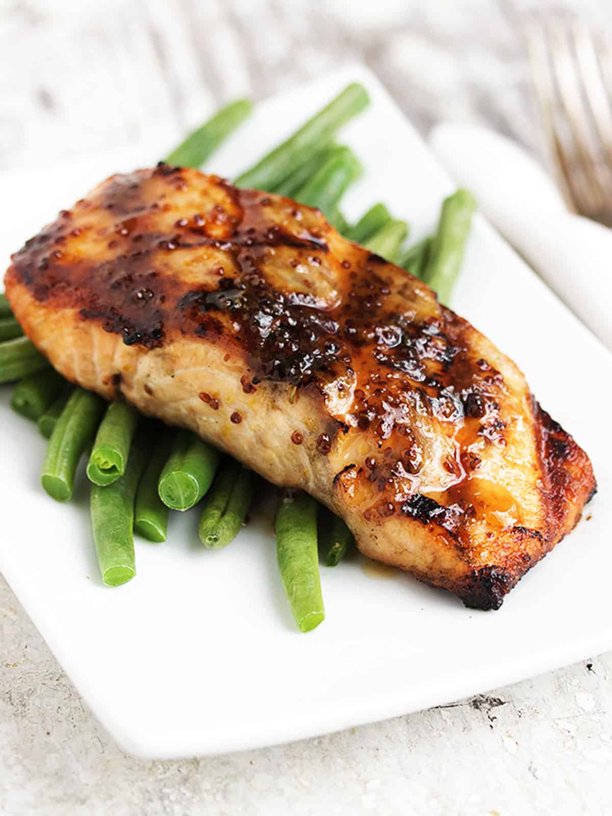 grilled maple mustard salmon on plate with green beans