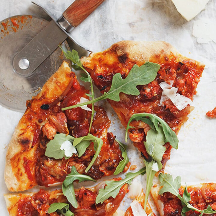 chorizo and manchego cheese pizza sliced on parchment