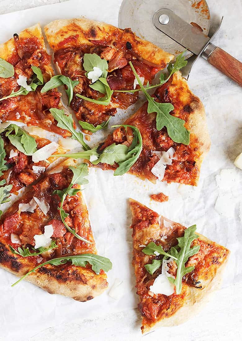 chorizo and manchego cheese pizza sliced on parchment