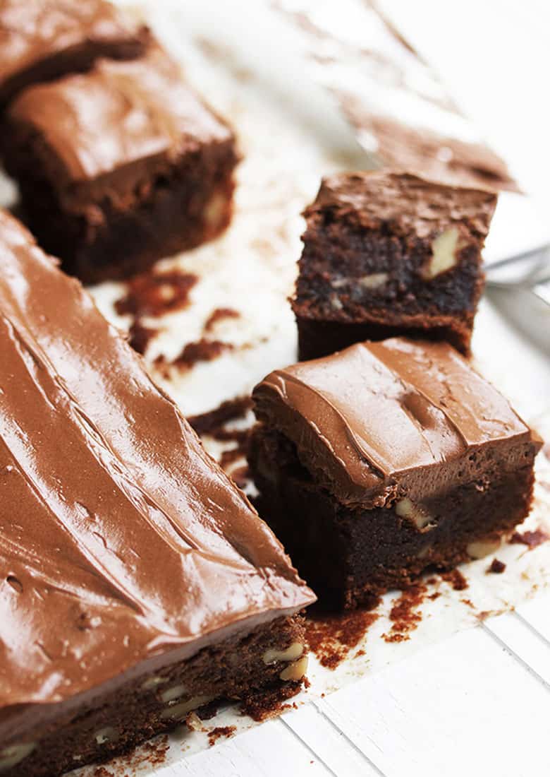 frosted brownies cut on parchment