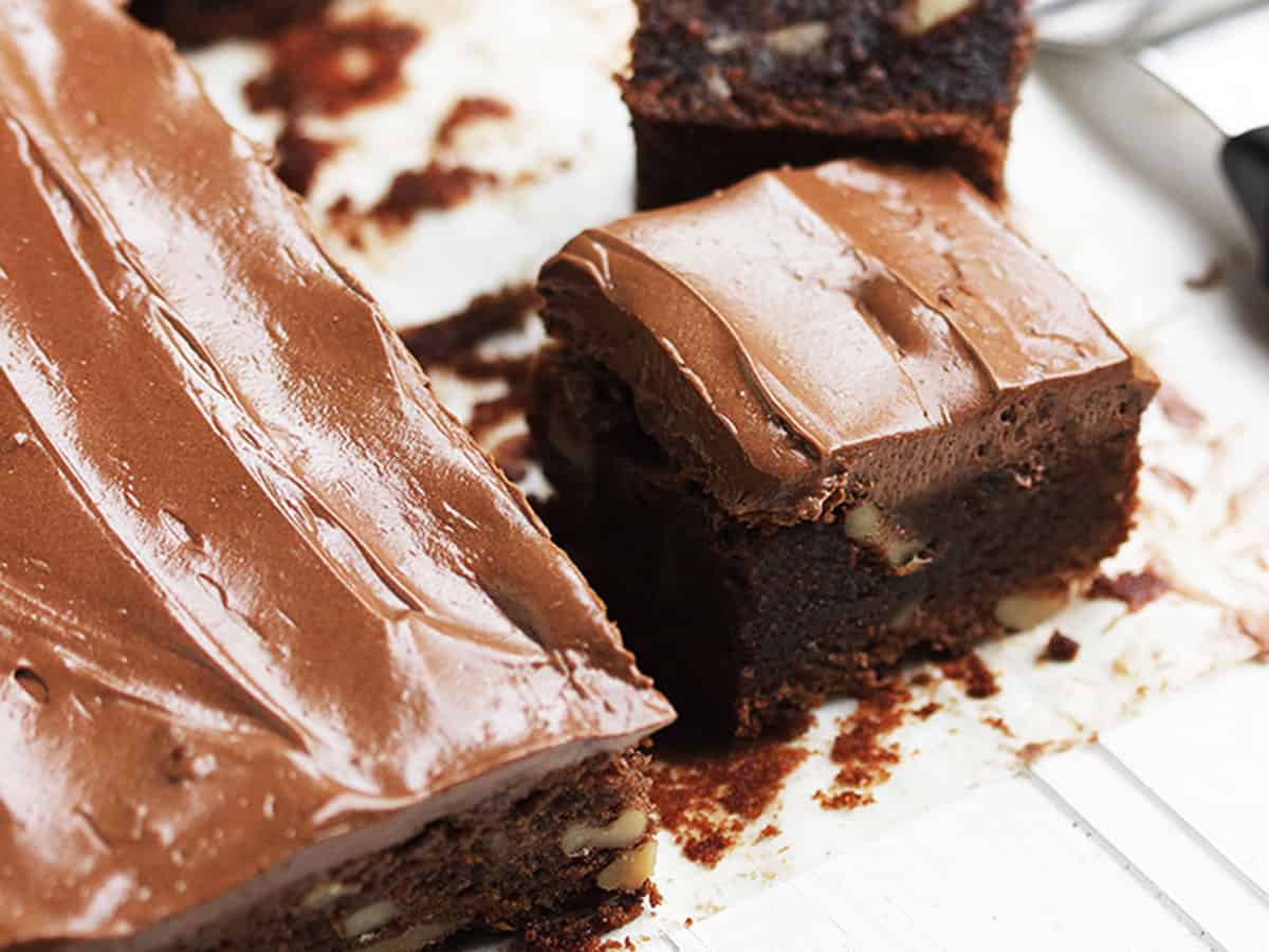 frosted brownies cut on parchment