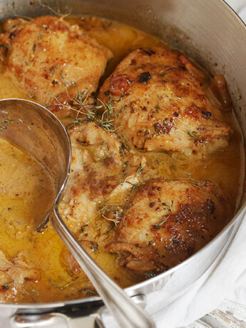 mustard chicken in skillet with spoon