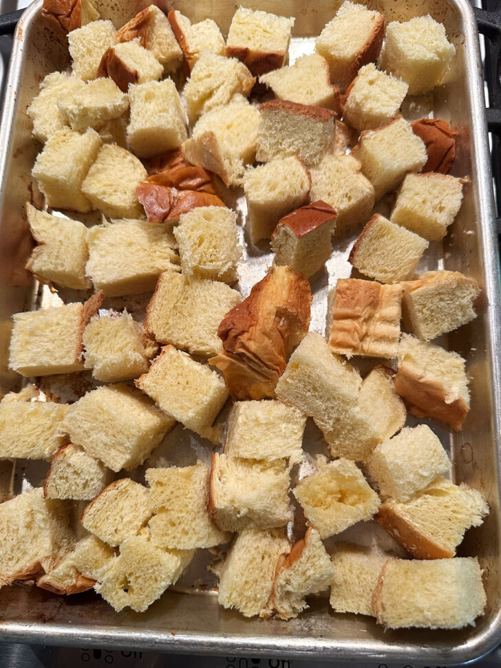 cubed bread on baking sheet before going in the oven
