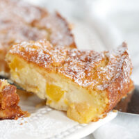 peaches and cream cake sliced on plate