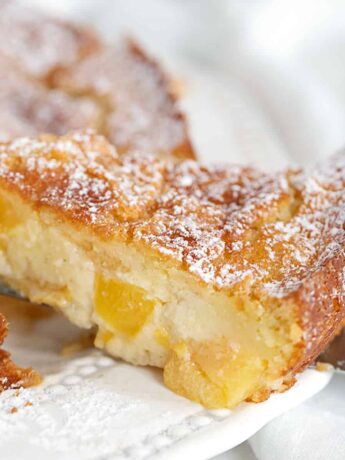 peaches and cream cake sliced on plate