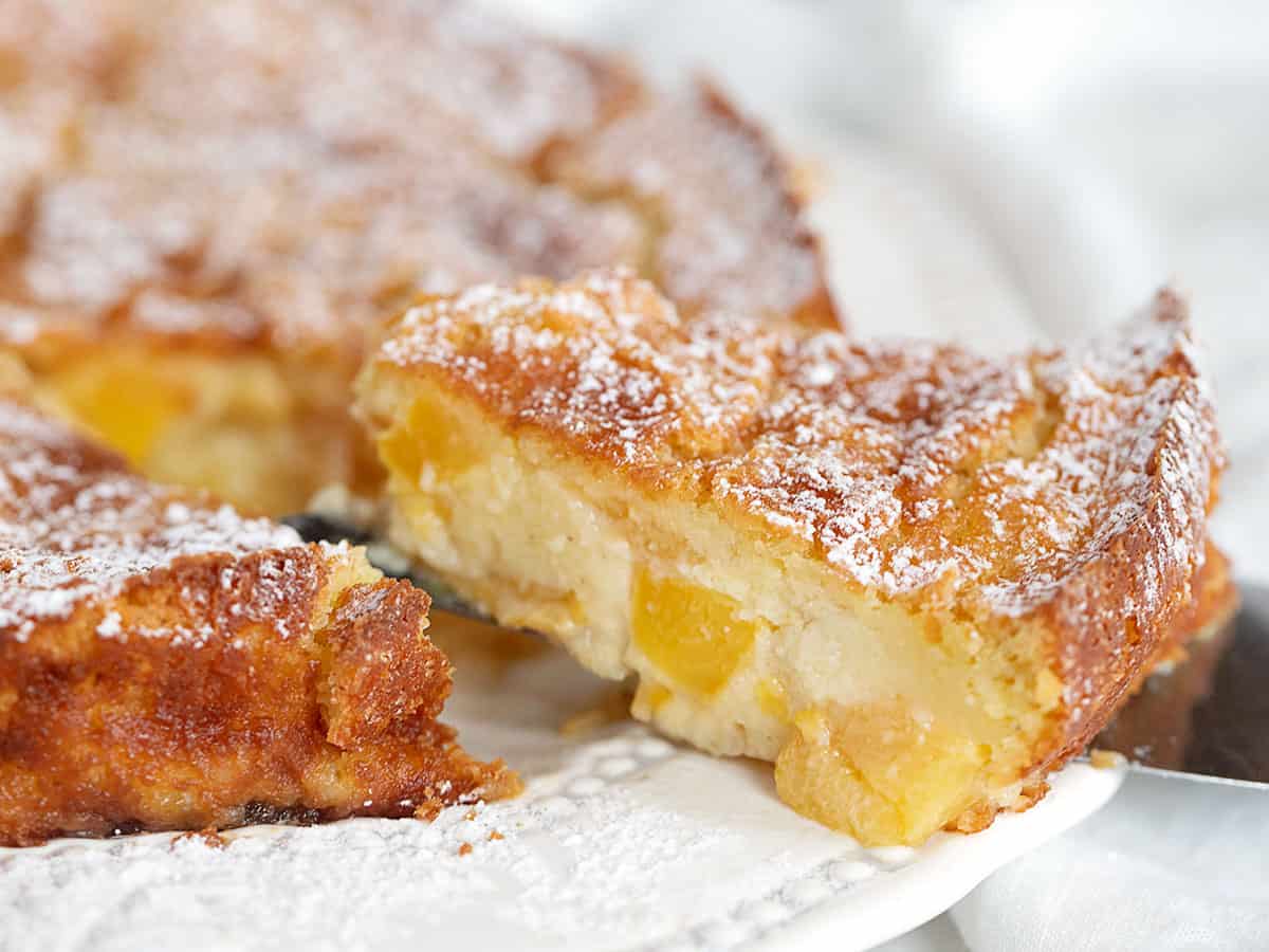 peaches and cream cake sliced on plate