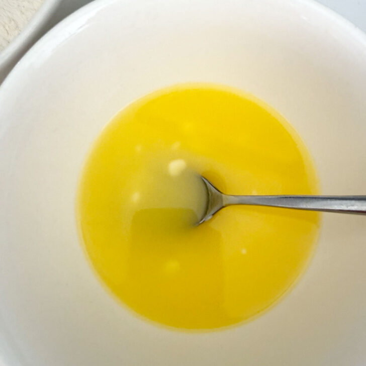 Butter melted in a small bowl.