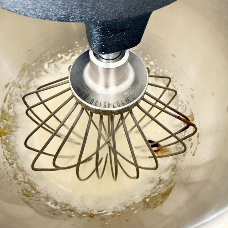 Eggs and sugar whipped together in the mixing bowl.