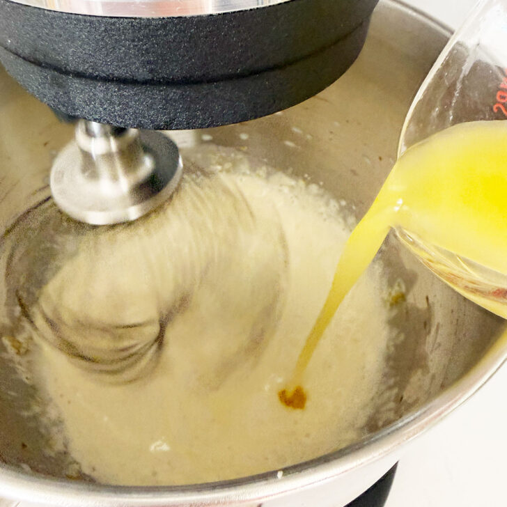 Adding the melted butter to the mixing bowl.