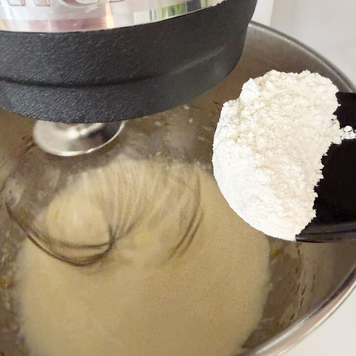 Adding the flour mixture to the mixing bowl.