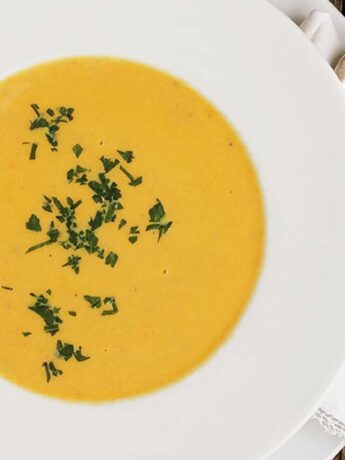 creamy carrot ginger soup in white bowl