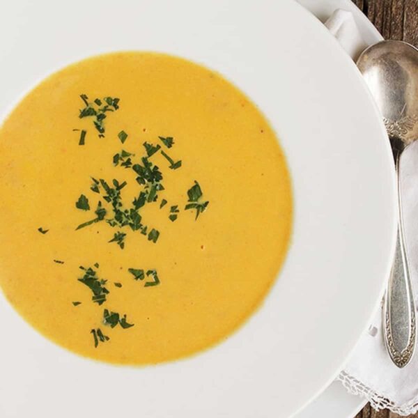 creamy carrot ginger soup in white bowl