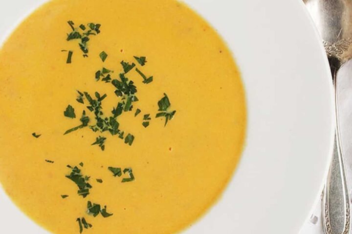 creamy carrot ginger soup in white bowl