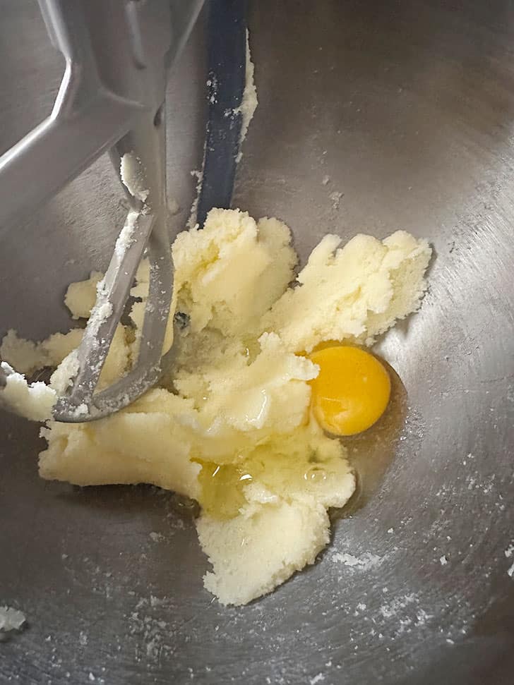 adding egg to creamed butter and sugar