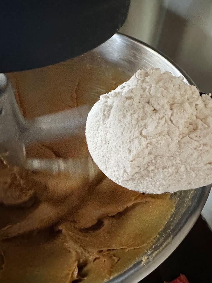adding dry ingredients to dough