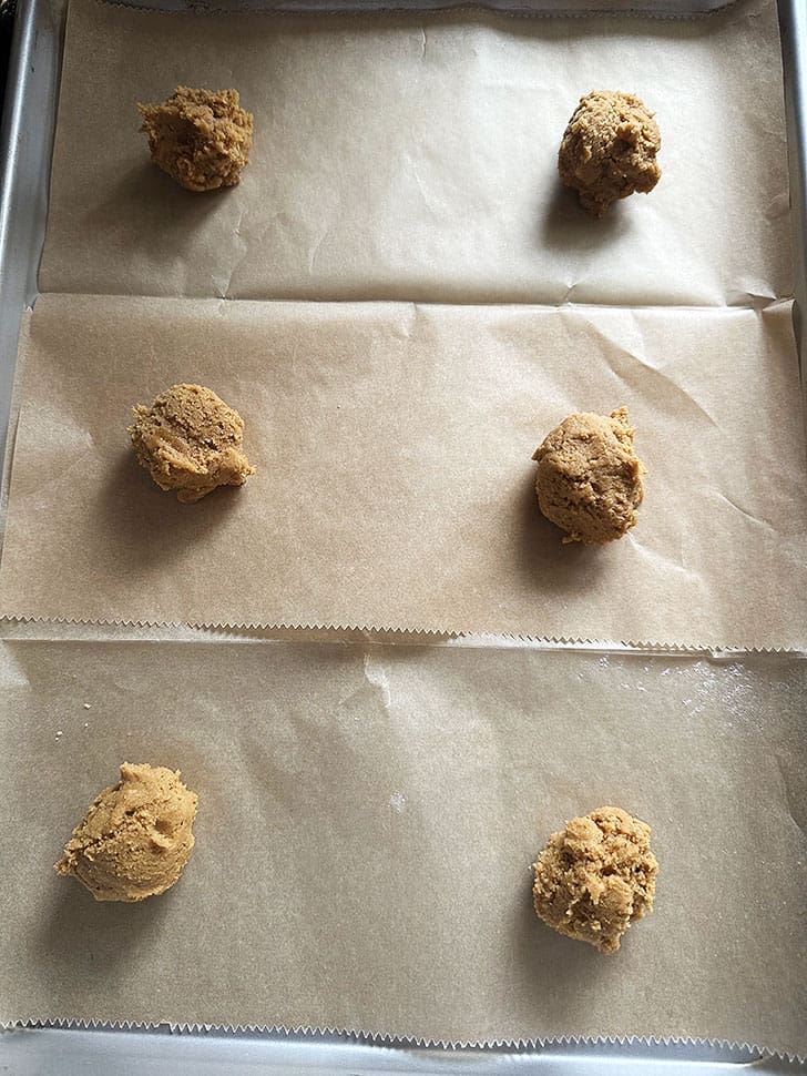 dollops of dough on parchment lined baking sheet