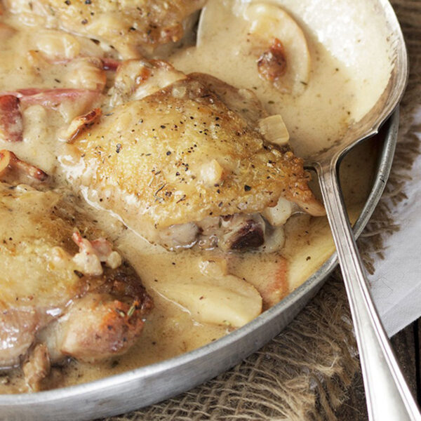 chicken thighs with apples and bacon in skillet
