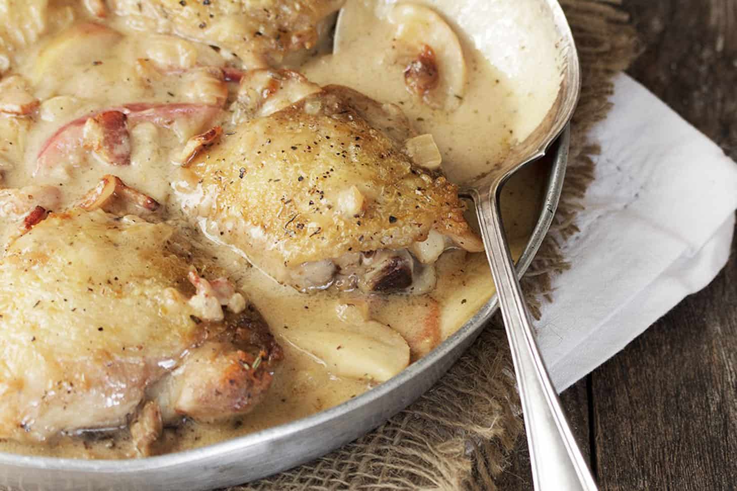 chicken thighs with apples and bacon in skillet