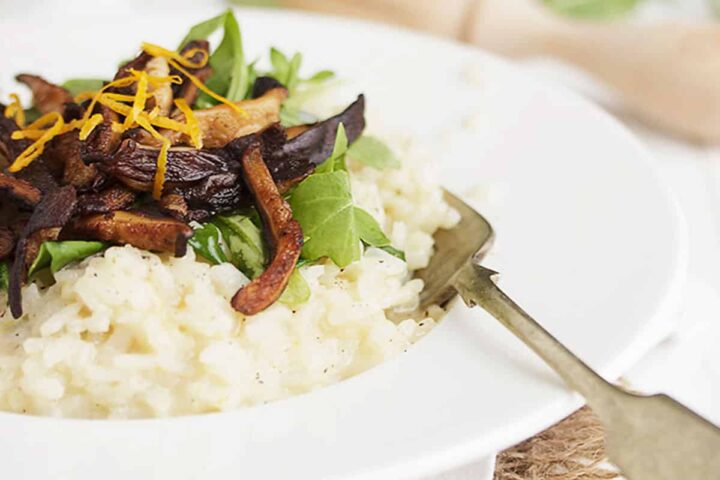 meyer lemon risotto in bowl with pea shoots