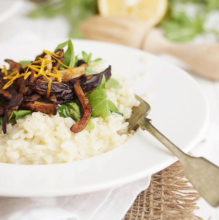 meyer lemon risotto in bowl with pea shoots