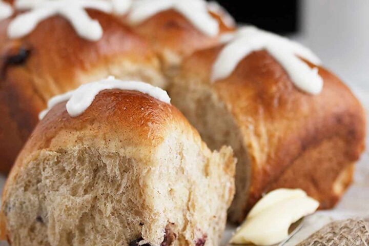 blueberry lemon hot cross buns with knife and butter