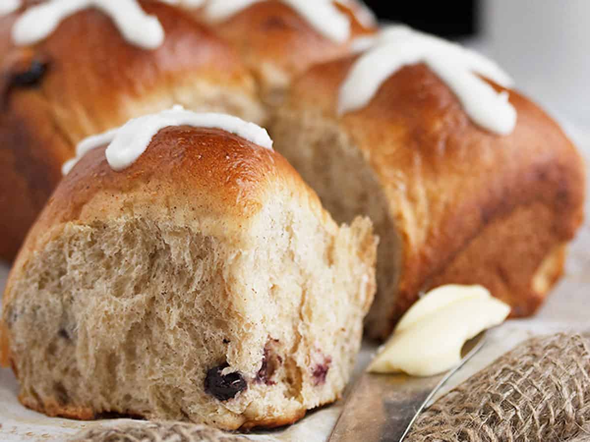blueberry lemon hot cross buns with knife and butter