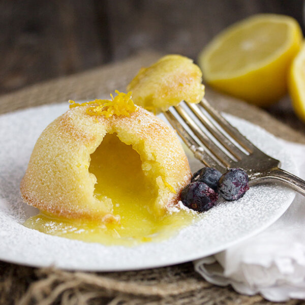 lemon lava cake on plate with blueberries