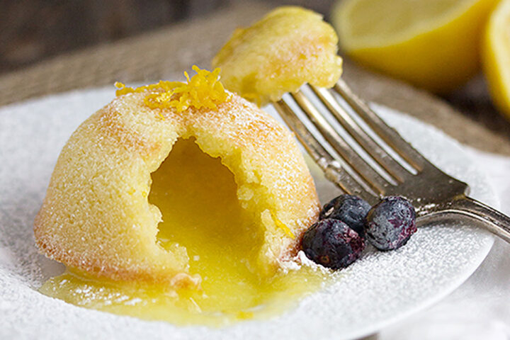lemon lava cake on plate with blueberries