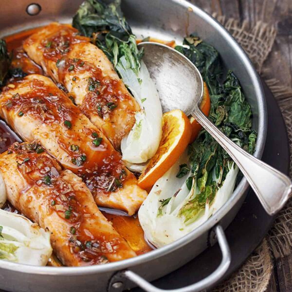 spicy orange salmon with bok choy on platter