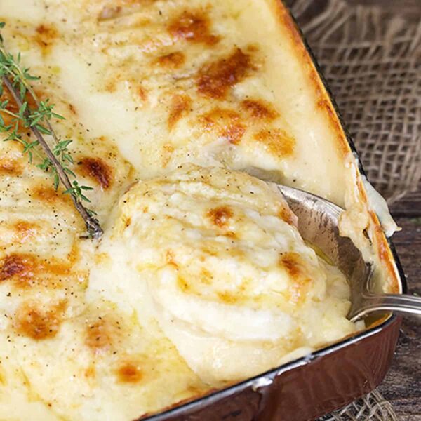 scalloped potatoes with bacon and cheese in casserole dish