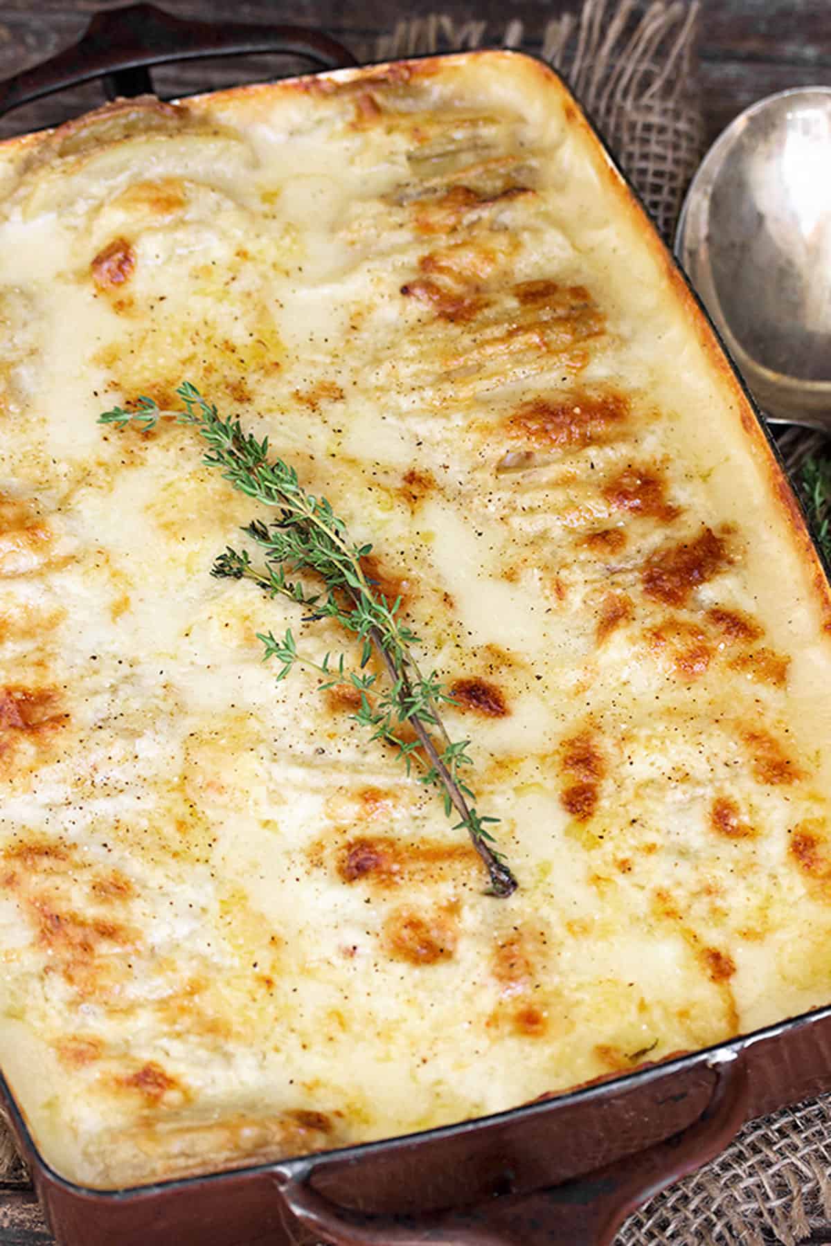 scalloped potatoes with bacon and cheese in casserole dish