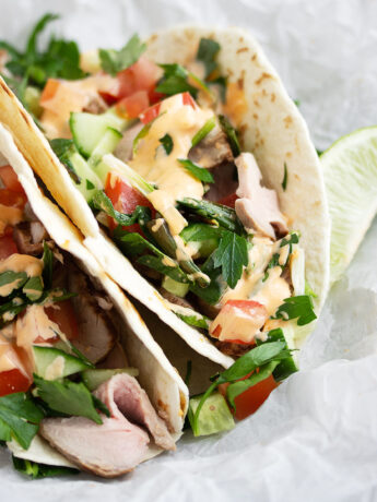 Asian inspired pork tacos on parchment paper