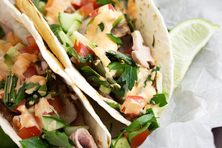 Asian inspired pork tacos on parchment paper
