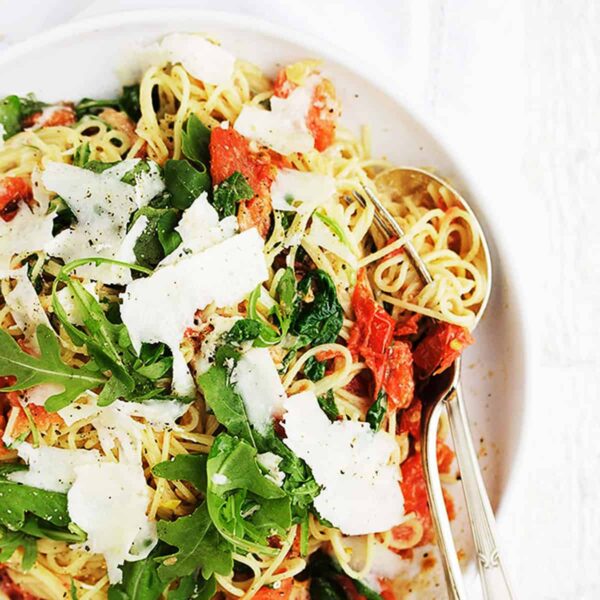 pasta with mascarpone and blistered tomatoes on white plate