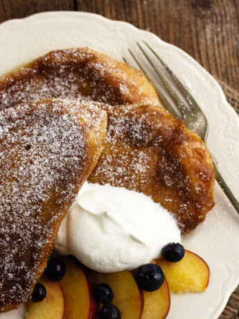 creme brulee french toast on plate with fruit