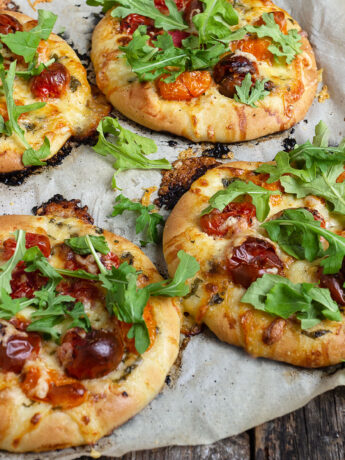 mini cherry tomato pizza on parchment paper