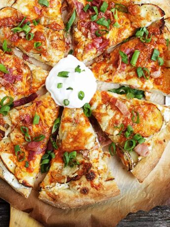 spicy perogy pizza sliced on pizza peel