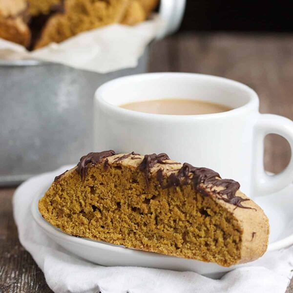 pumpkin spice latte biscotti on plate with coffee