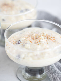 Creamy old-fashioned stovetop rice pudding in a serving glass dish.