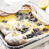 Finnish pancake with blueberries in pan
