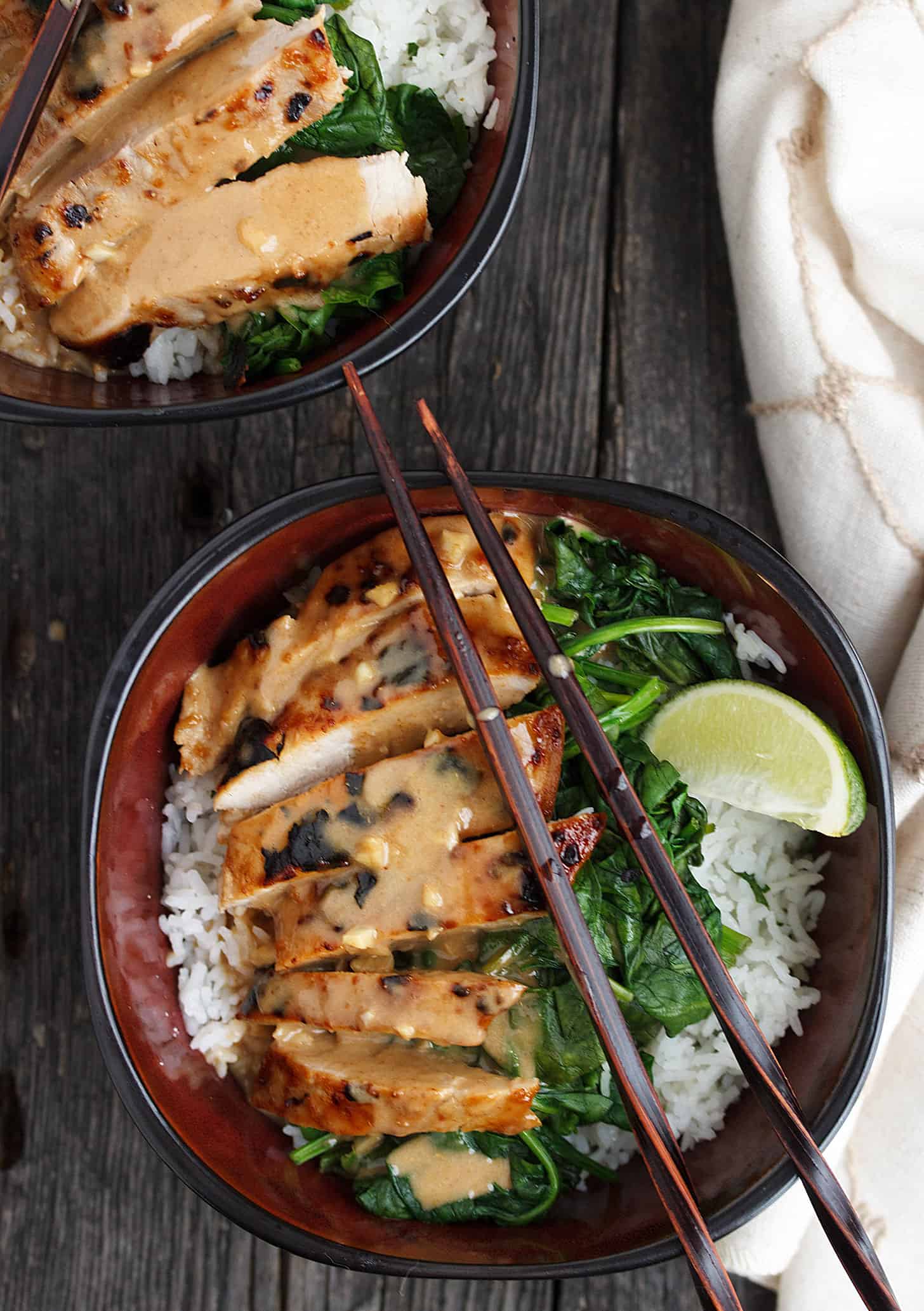 Pork Rice Bowl with Peanut Sauce in bowl with chopsticks.