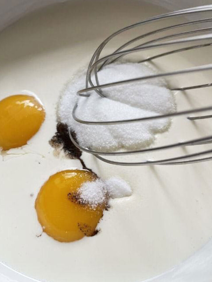 Whisking together the eggs, sugar, cream and vanilla.