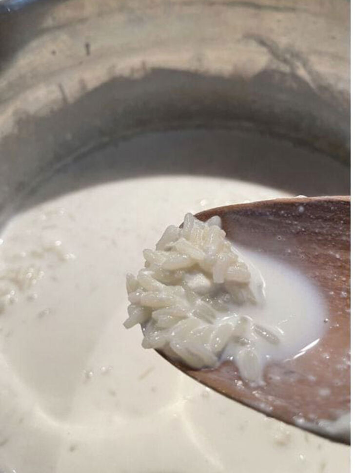 Spooning out some rice to taste test.