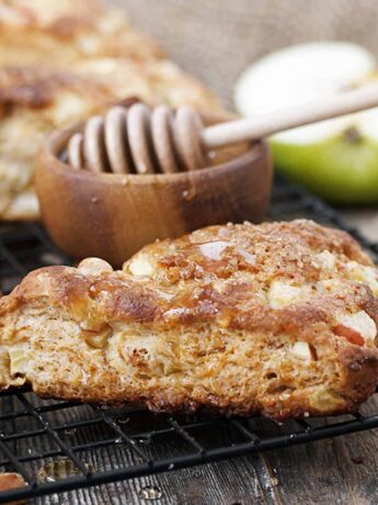 apple buttermilk scones on cooling rack with honey