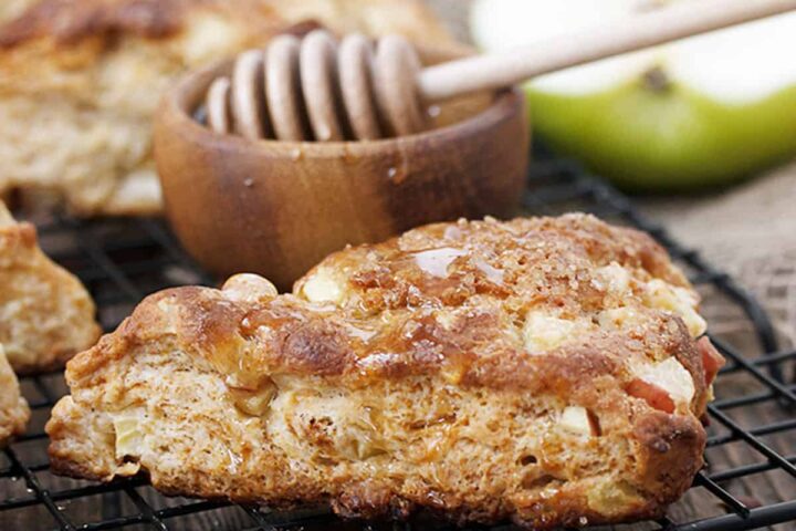 apple buttermilk scones on cooling rack with honey