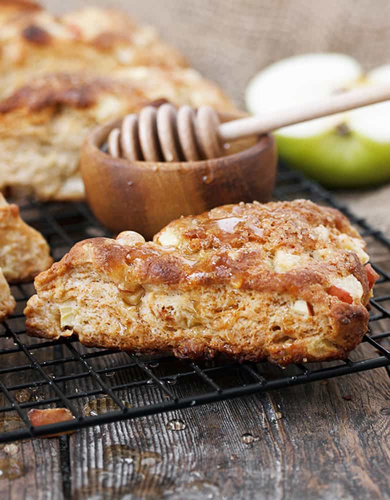 apple buttermilk scones on cooling rack with honey