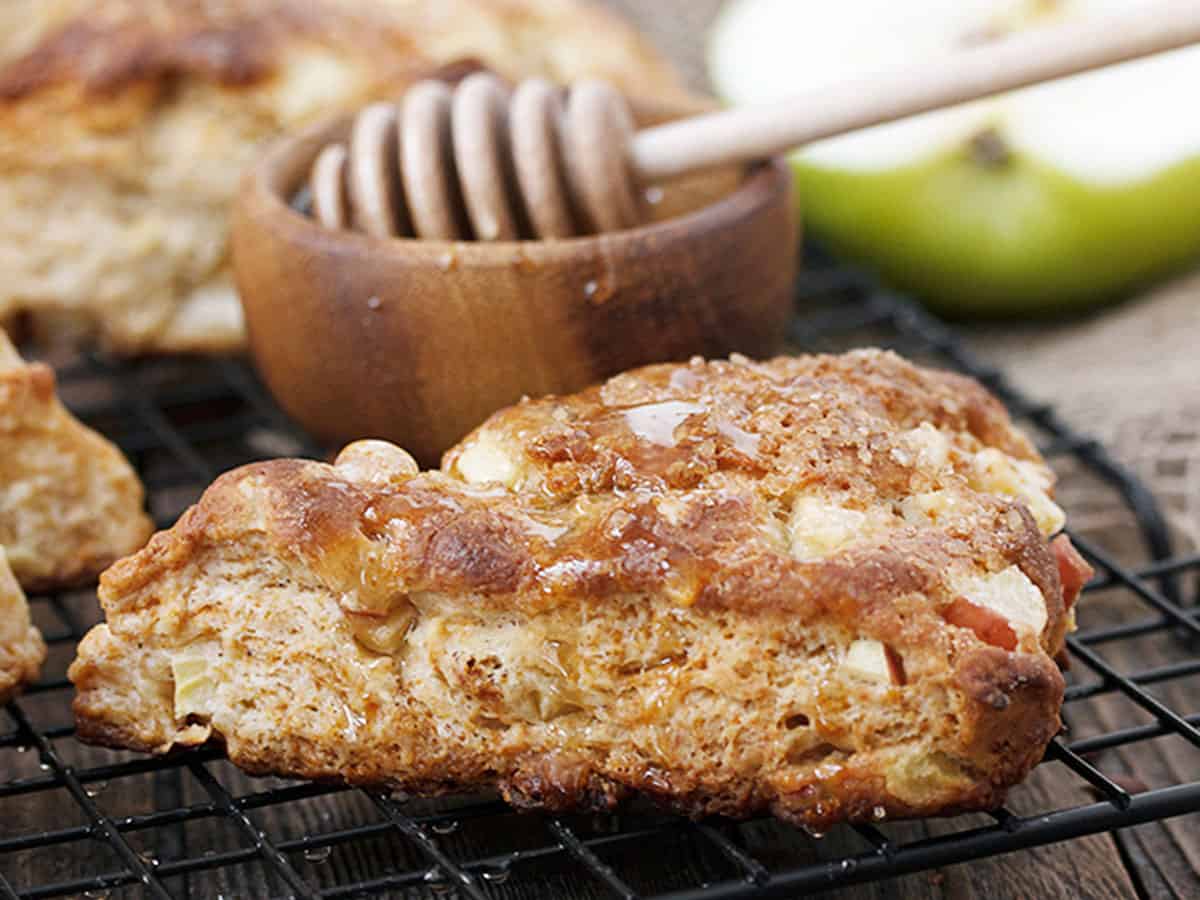 apple buttermilk scones on cooling rack with honey