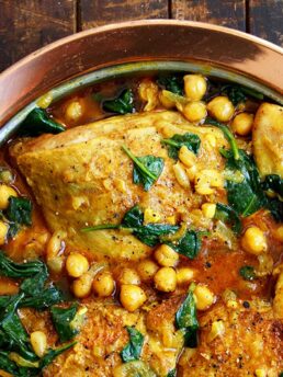 chicken chickpea curry in copper dish