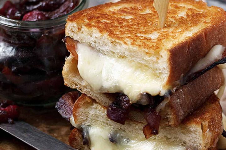 cheese curd grilled cheese on plate with bacon marmalade