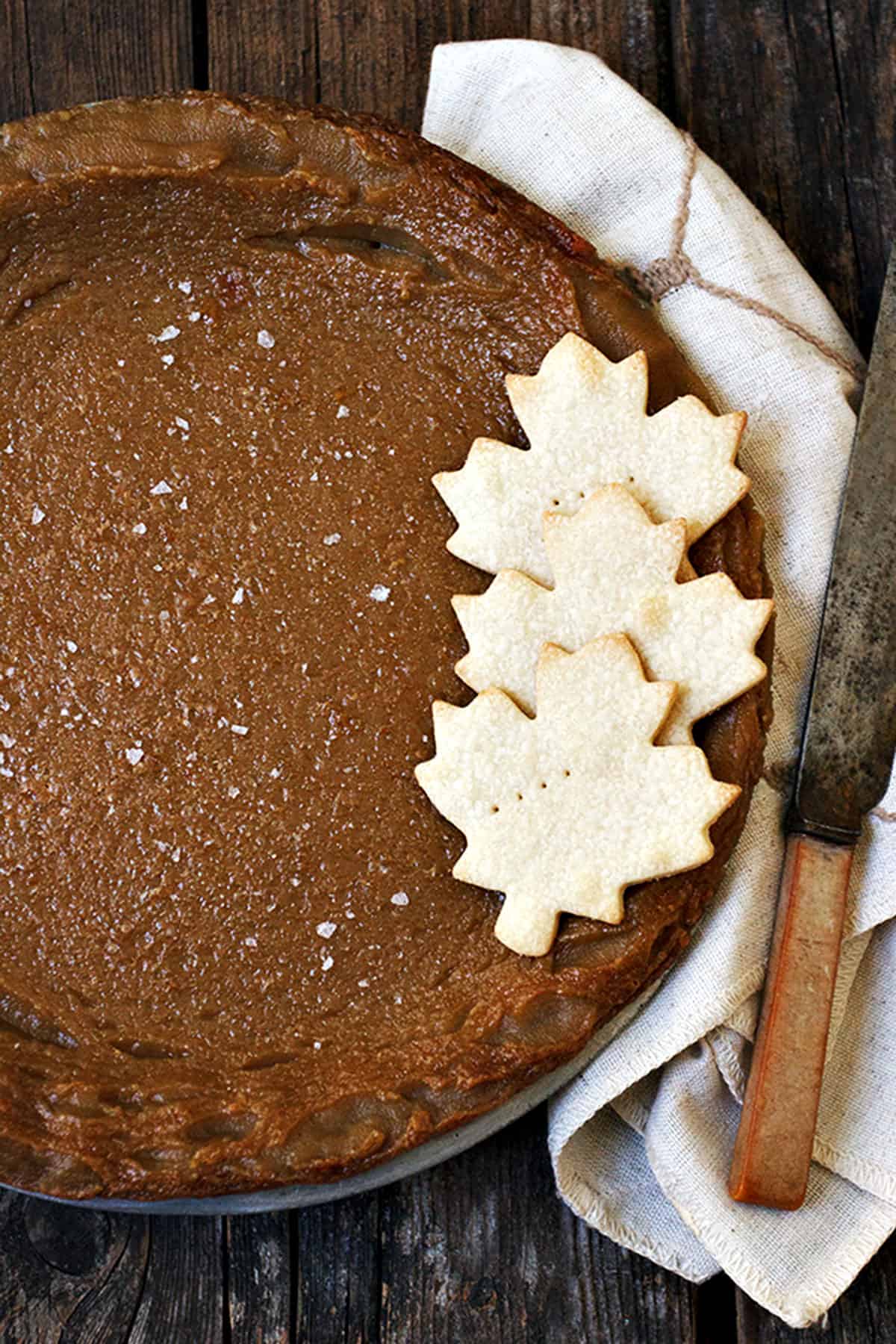 Canadian maple pie in plate with pastry maple leaves
